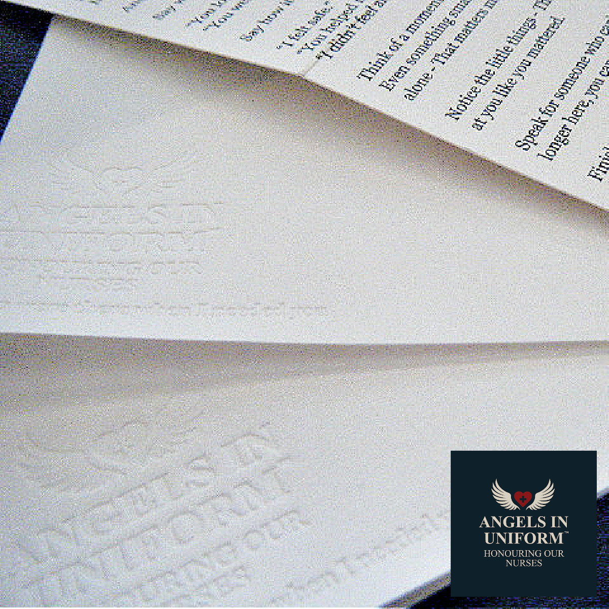Close-up of debossed paper with text  "you were there when I needed you" and 'Angels in Uniform' logo.